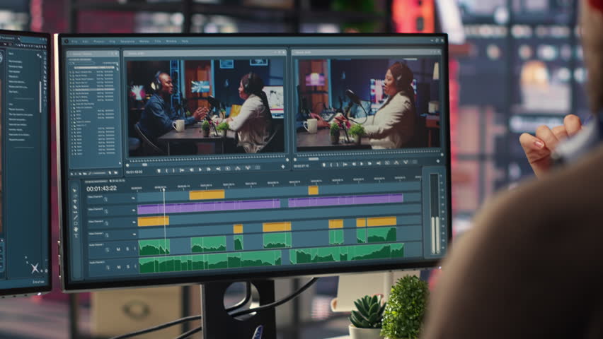 Video editors team working with AI chatbot and montage maker software, editing a background video and mixing clips on dual monitors. Professional man and woman in creative process. Camera B.