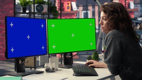Employee in office working on PC with isolated copy space on dual monitors, creative agency modern setup. Woman focused on graphic design, coding or AI powered tasks in optimized space. Camera B. - Powered by Shutterstock - Get 15% off with code: PIKWIZARD15