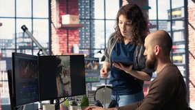 Man and woman collaborate on content creation for the media industry, analyzing data and insights, editing video footage and adjusting branding elements. AI powered. Camera B. - Powered by Shutterstock - Get 15% off with code: PIKWIZARD15