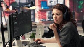 Female day trader examines stock market graphs on dual monitors, tracking financial growth to share prices. Trading interface provides real time data for buying and selling shares. Camera B. - Powered by Shutterstock - Get 15% off with code: PIKWIZARD15