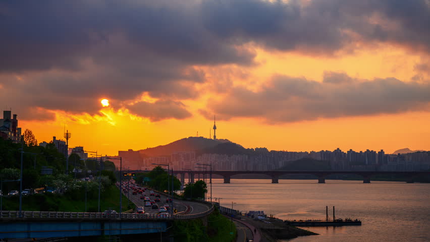 4K Time Lapse Video of Seoul Sunset Viewpoint along Han River and Bridge with Namsan Mountain and N Seoul Tower in the Background, Seoul, South Korea