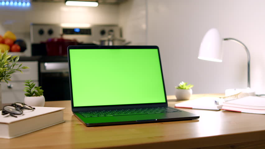 A High Resolution Mock Up Of A Laptop With A Green Screen Display In A Home Work Room Setting, Ideal For Video Call Backgrounds, Website Templates Or Game Application Previews.