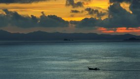 An aerial shot of a boat gliding across the ocean, with dark mountain silhouettes and a golden sunset peeking through stormy clouds, evoking a sense of peaceful solitude and nature’s power. Thailand.
 - Powered by Shutterstock - Get 15% off with code: PIKWIZARD15