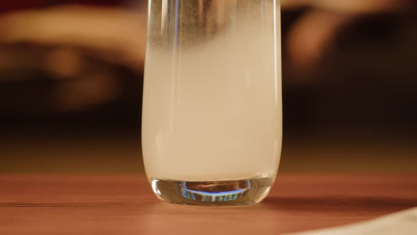 Effervescent tablet vitamin C aspirin nutritional supplements in glass with yellow carbonated water, sport medication, healthy morning. Healthy vitamins D drugs