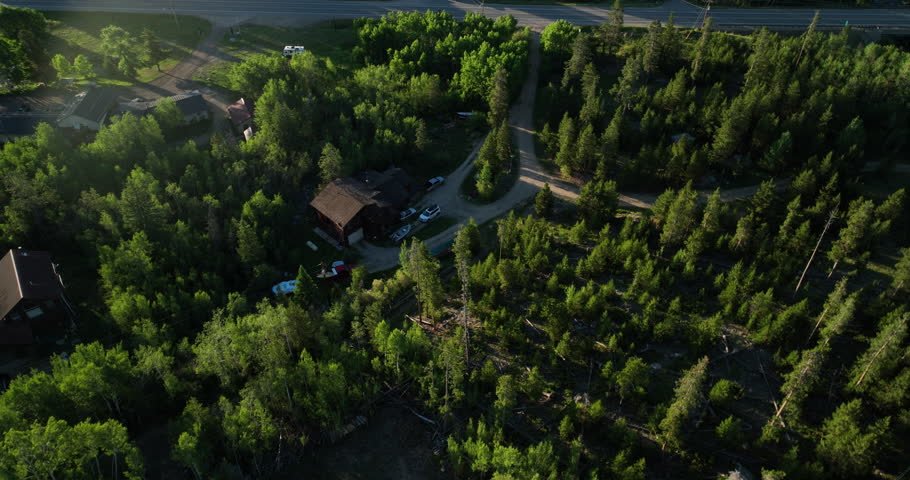 Tilting Drone shot of sunrise over the mountains at Shadow Mountain Lake, Colorado