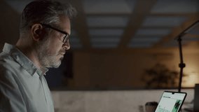 Senior overworked businessman taking off glasses, feeling tired and rubbing his eyes, then closing laptop and leaving office at night - Powered by Shutterstock - Get 15% off with code: PIKWIZARD15