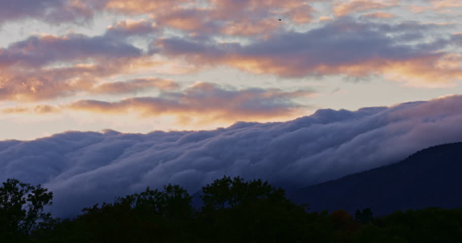 Breathtaking autumn timelapse in Verbier, Switzerland. Clouds drift over colorful Alpine forests and peaks, capturing the serene passage of time in the Swiss Alps. Perfect for nature projects.