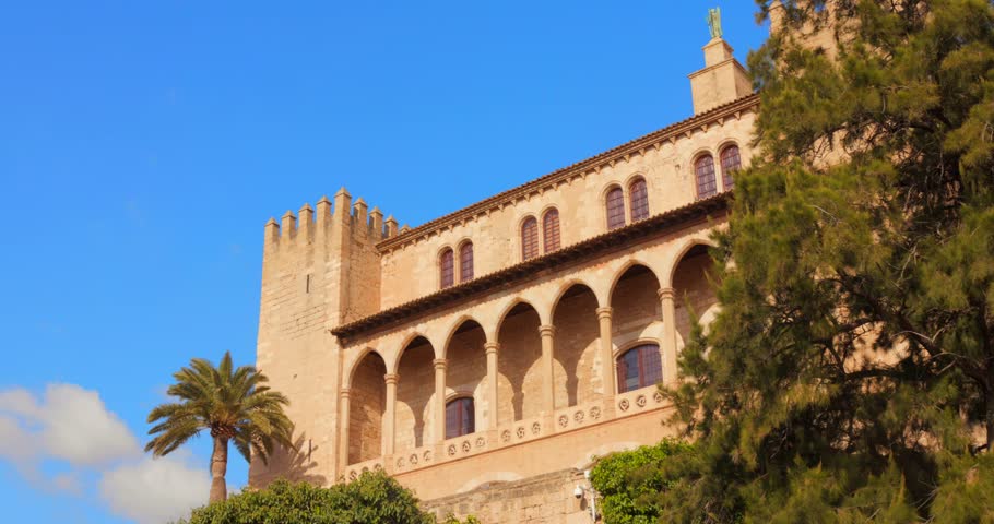 The Royal Palace of La Almudaina Stands Tall Amid Greenery in Palma de Mallorca, Spain - Low Angle Shot