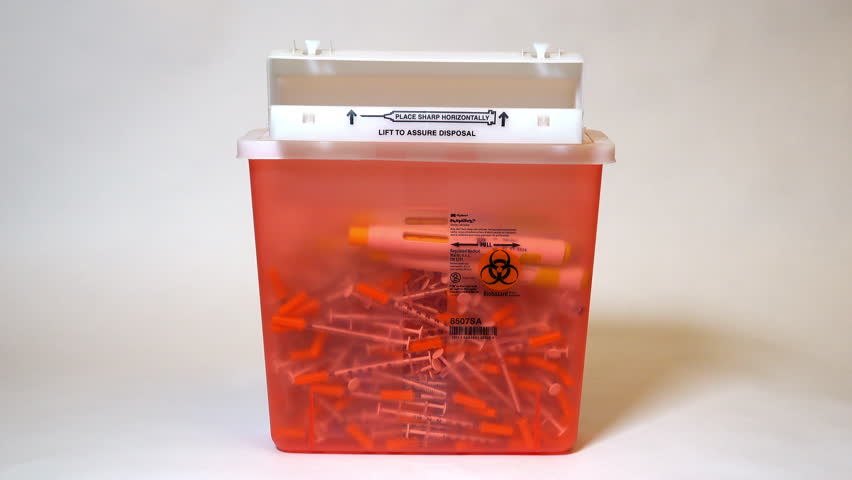 Injection pen is dropped into a sharps container that automatically closes when at full capacity.