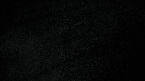 Tiny dust randomly flying in the smoky air, empty space template for objects. Many dust particles white powder floating in darkness on empty black contrast background. Slow motion. - Powered by Shutterstock - Get 15% off with code: PIKWIZARD15