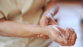 Close up of elderly hand gently holding wrist showing care and support with soft skin touch in warm light setting - Powered by Shutterstock - Get 15% off with code: PIKWIZARD15