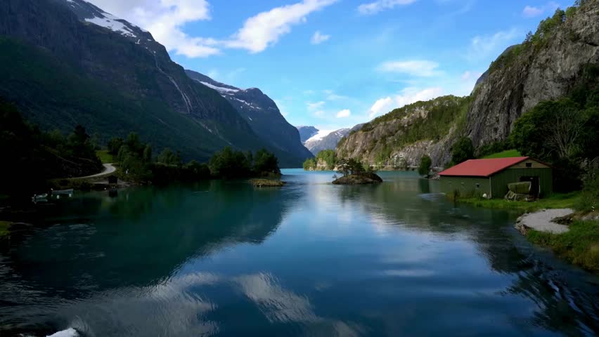 Serene Mountain Lake with Red Roof Cabin Reflection