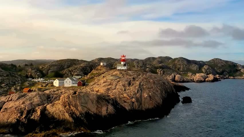 Coastal Lighthouse and Rocky Shoreline Aerial View