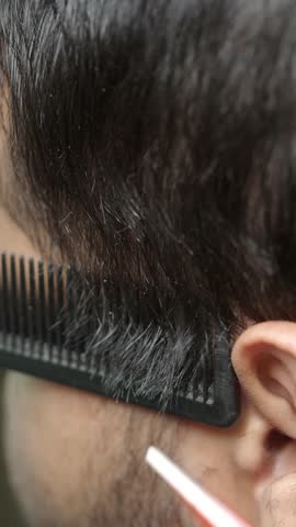 Skillful haircut techniques at a barber shop in a bustling city