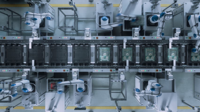 Automated Robotic Arms Assembling Circuit Boards on a Conveyor. Microelectronics Manufacturing in a Modern Facility. High-Tech Technology Production in a Futuristic Industrial Environment. Top Down