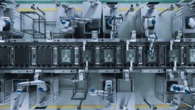 Top Down Footage with Automated Factory Floor with Robotic Arms Producing Computer Components, Fabricating Circuit Boards with Microchips. Futuristic AI Manufacturing of Robotics. Static Shot - Powered by Shutterstock - Get 15% off with code: PIKWIZARD15