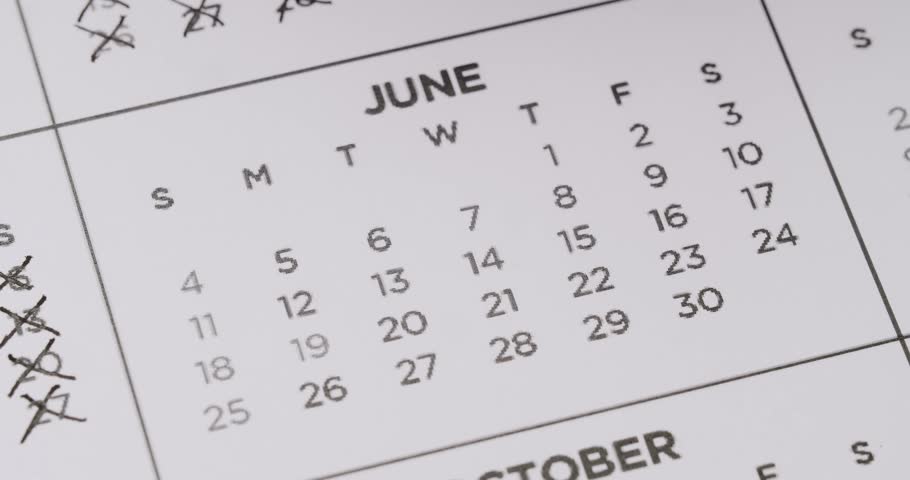 Someone is using a black pen to mark every date in June off a printed calendar. They put multiple x's over each date, symbolizing the passing of time or counting down the days. Dates On Calendar