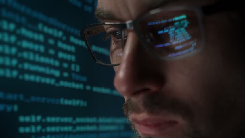 Close-up of male data scientist of cyber security professional wearing glasses, working online, against glowing analytics and data on background. Software engineer analysing data - Powered by Shutterstock - Get 15% off with code: PIKWIZARD15