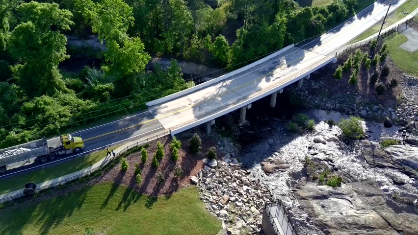 Aerial view of a mill pond dam in South Carolina with pollen floating on the water