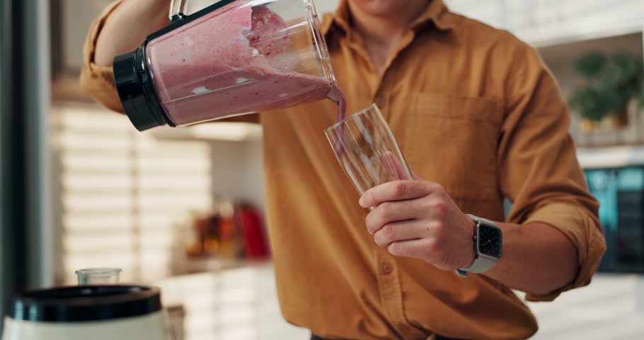 Smoothie, drinking and man in kitchen with blender, glass and pouring beverage for gut health. Series, male nutritionist and fresh ingredients in home for detox diet, protein shake enjoy flavor