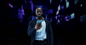 Young Black Man Standing in a Virtual World, Digital Holograms Hover Around Him. Visualization of Smartphone App Content, Social Media Interface with Different Live Streams, Gaming, Online Channels - Powered by Shutterstock - Get 15% off with code: PIKWIZARD15