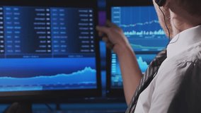 Trader works in office using workstation and analysis technology. Workplace of professional crypto exchange broker. Close-up portrait. Global financial markets, business strategy, currency exchange - Powered by Shutterstock - Get 15% off with code: PIKWIZARD15