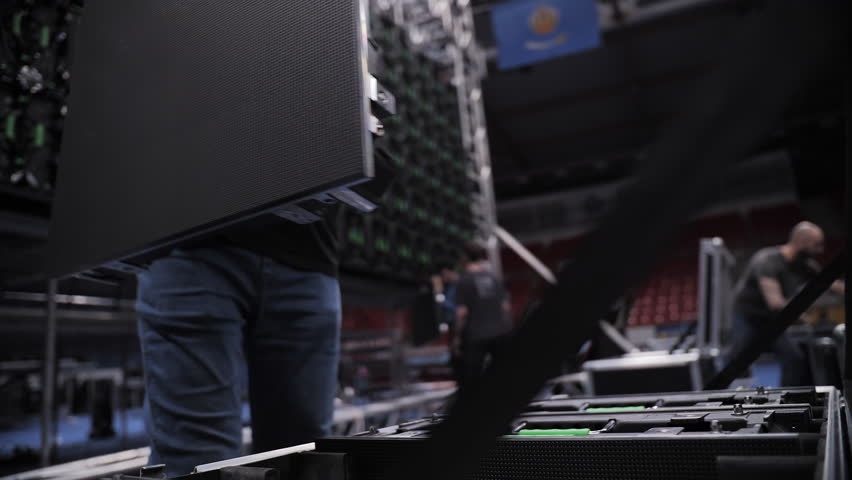 Worker placing LED panel into transport case