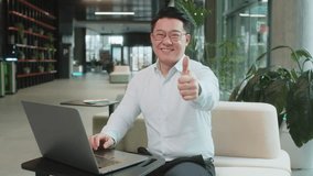 Like. Happy young businessman guy working on laptop looking approvingly at camera showing thumbs up, like sign positive something good, positive feedback sitting in modern office lobby. Businesspeople - Powered by Shutterstock - Get 15% off with code: PIKWIZARD15