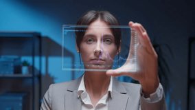 Confident Caucasian woman in formal suit holding futuristic transparent interface with digital controls. Interacting with high-tech display. Connecting to server after analyzing live stock graph. - Powered by Shutterstock - Get 15% off with code: PIKWIZARD15