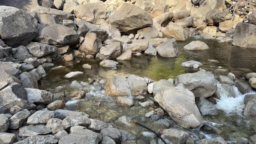 Lower Yosemite Falls in the daytime in Yosemite National Park SLOW TILT UP SLOW MOTION