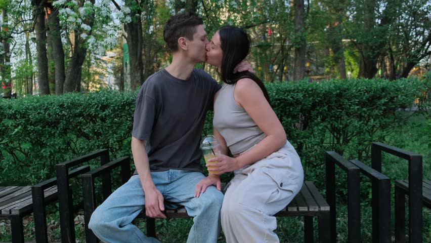 Man Waiting for a Girl in the Park. Simple Romantic Moment. Urban Romance. Natural Couple Sitting on Bench and Talking. Honest Relationship Scene. Authentic Love and Emotional Connection