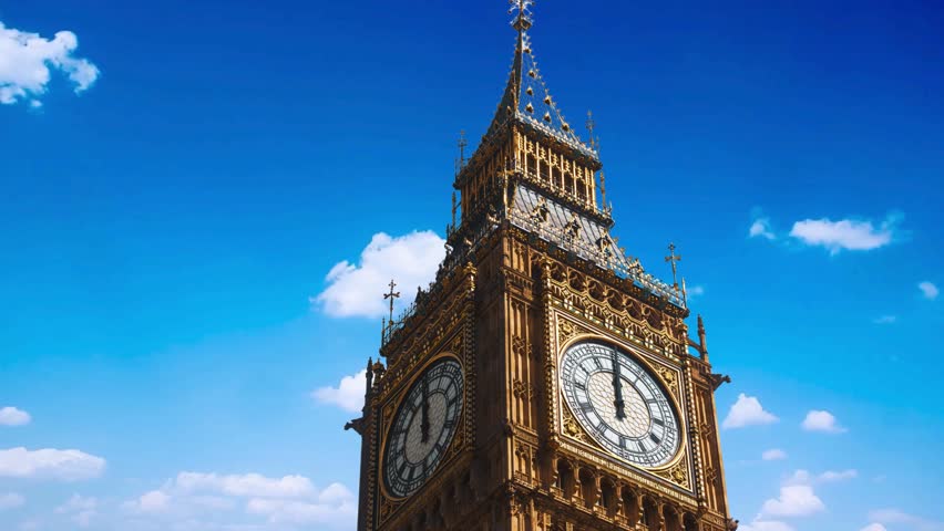 Beautiful sunset view of the Big Ben Clocktower in London, England, with the fairy lights from the Trafalgar Square Christmas market in front Big Ben, also known as Elizabeth Tower, is seen at night i