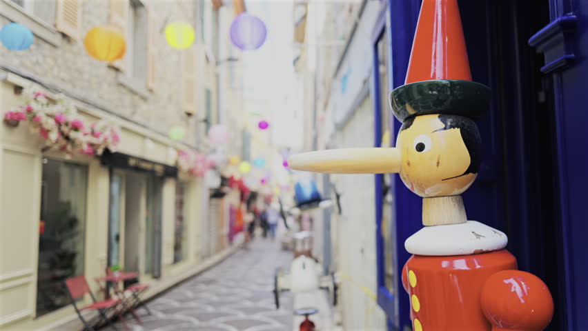 Pinocchio sculpture made out of wood on the streets of Antibes, France