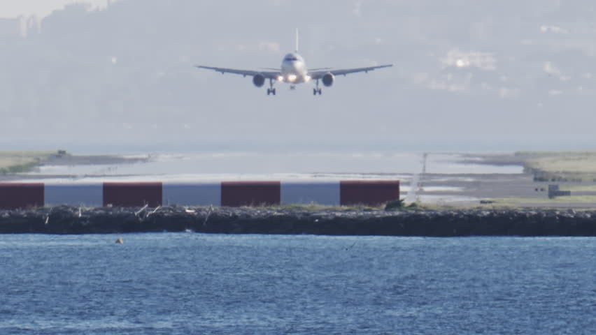 Distant view of airplanes landing at the Nice Cote d'Azur Airport in daylight