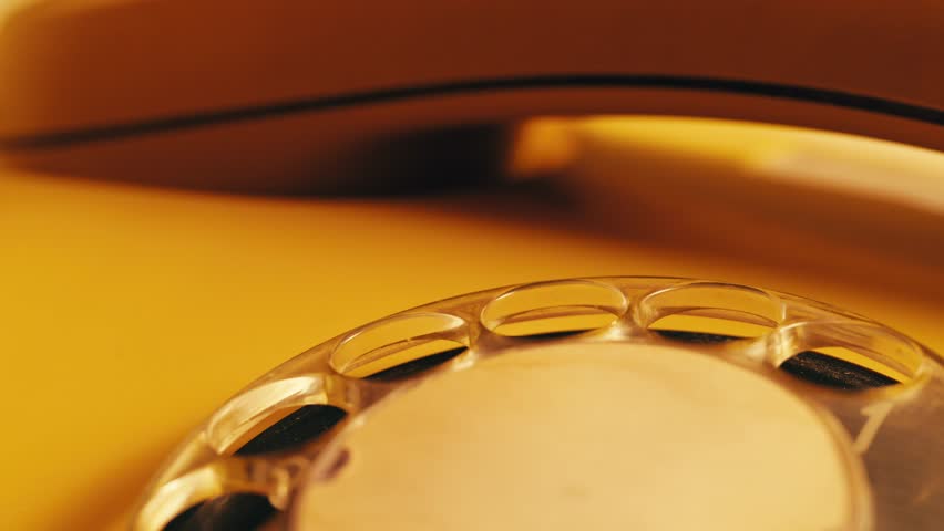 Retro vintage phone, red rotary telephone is displayed on a wooden desk, adding a nostalgic touch