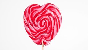 Red Colorful Spiral Lollipop Video Rotation. Sweet Caramel Candy on a Stick is spinning. Confectionery Theme. Round Twisted Sweets in Heart Shaping - Powered by Shutterstock - Get 15% off with code: PIKWIZARD15