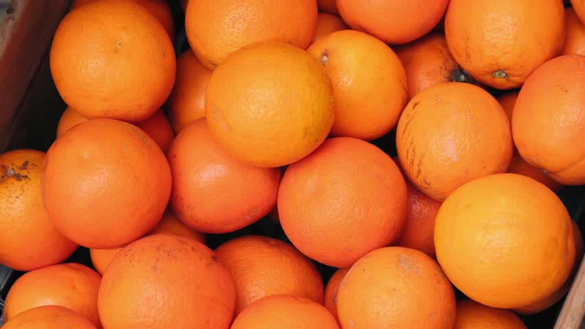 Close up of wooden box with ripe sweet oranges. Harvest time. High quality 4k footage