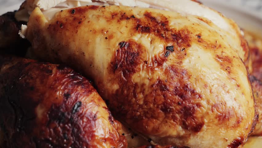 Chef cuts the roasted chicken, chopping tasty grilled chicken. High quality 4k footage