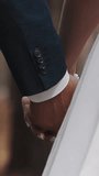 Newlywed wife and husband walk joining hands with interlaced fingers at wedding ceremony across park closeup slow motion. Young man and woman couple in love - Powered by Shutterstock - Get 15% off with code: PIKWIZARD15