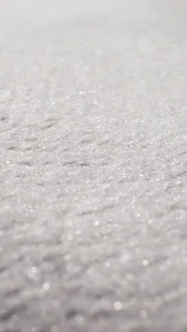 White fabric with glitter threads at bright light extreme close view. Textile material texture sheet. Shiny flat cotton cloth textured surface