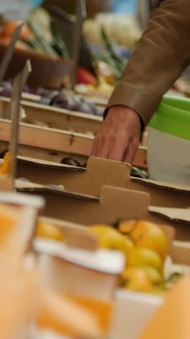 Market scene with hands sorting through fruits and vegetables, capturing the