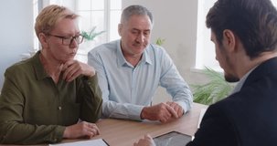 Consultant, agent or adviser conducts a professional meeting with a pair of senior clients in an office. They discuss financial, insurance, or real estate matters in a collaborative setting. - Powered by Shutterstock - Get 15% off with code: PIKWIZARD15