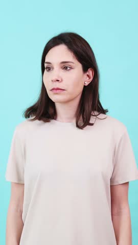 Woman suffering from back pain on turquoise background