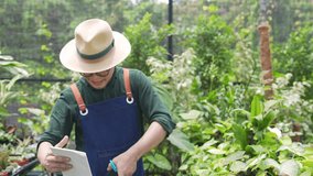 Small business entrepreneur and e-commerce online shopping. Asian man plant shop owner speaking on mobile phone, checking and preparing customer order. Gardener caring plant and flower in the garden. - Powered by Shutterstock - Get 15% off with code: PIKWIZARD15