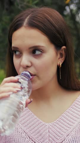 Hydration With Disgusting Water By A Girl In The Nature Outdoor In Park