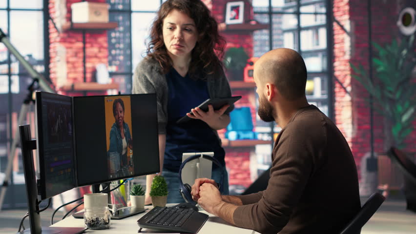 Team of experts work on social media content and video editing with dual monitors, AI tools and color grading software in a modern studio, enhancing visibility, engagement and reach. Camera B.
