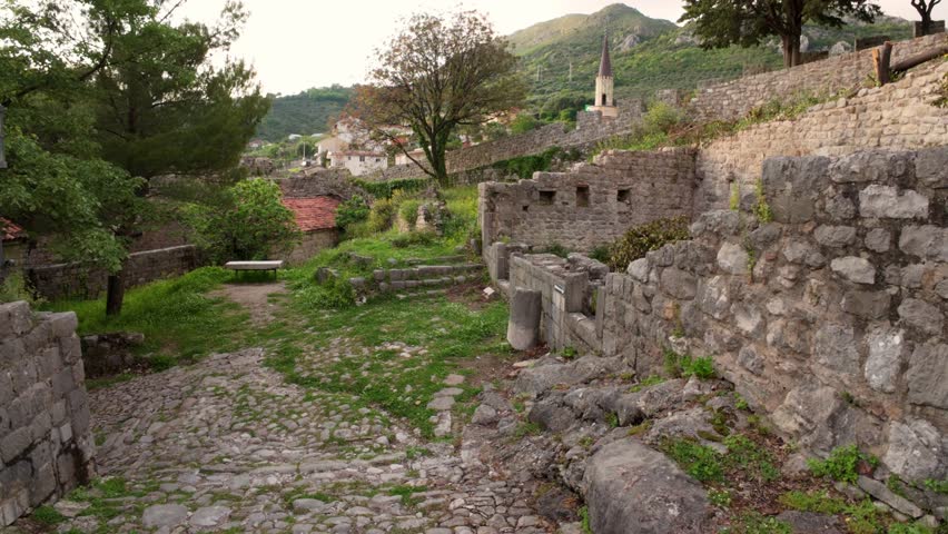 Explore the historic ruins and lush greenery of an ancient fortress in Montenegro, a perfect blend of nature and history.