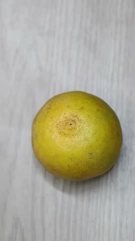 Sequential frames showing the peeling of an orange