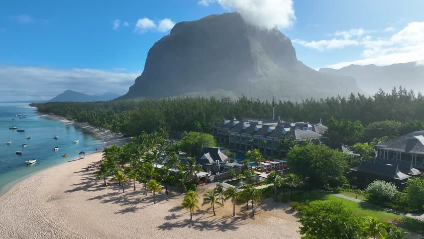 Aerial view of Le Morne beach in Mauritius with the UNESCO-listed Le Morne Brabant mountain and luxury beachfront resort in the foreground