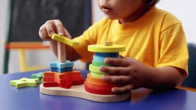 Child hands playing with didactic toys at preschool or daycare room. Education culture concept - Powered by Shutterstock - Get 15% off with code: PIKWIZARD15
